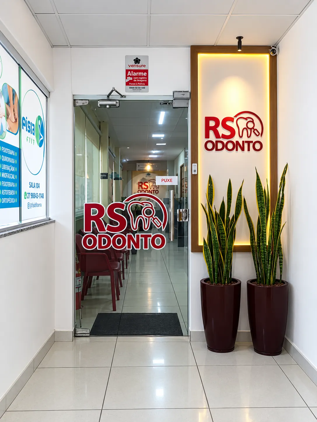 Entrada da RS ODONTO com porta de vidro e painel iluminado com o logo